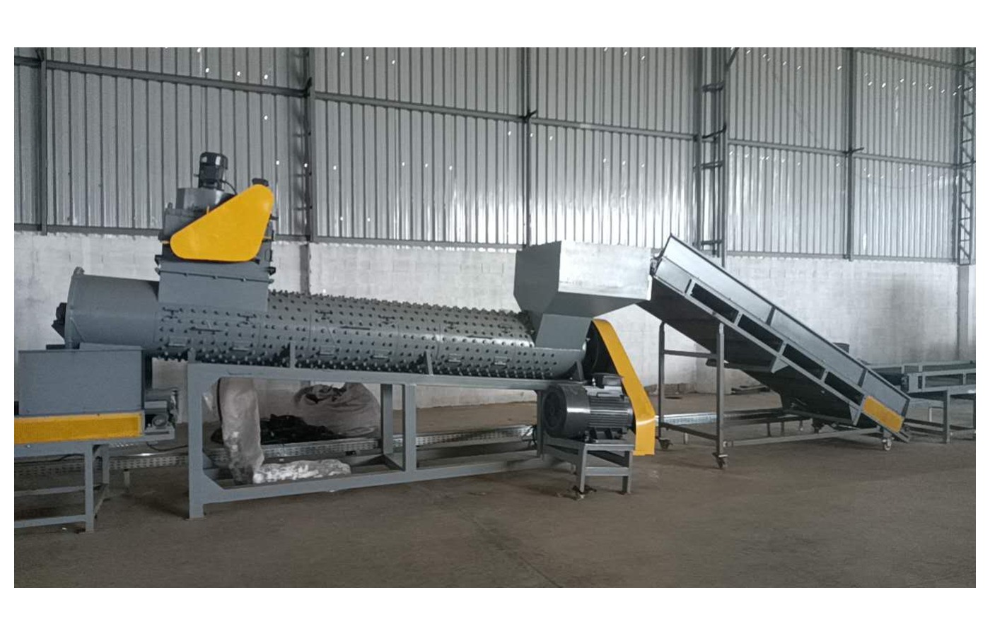PET bottle label remover installed in a machinery workshop
